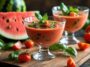 Fresh Tomato And Watermelon Gazpacho Soup Garnished With Basil Served In Glass Bowls On A Wooden Table With Vegetables And Fruit In Background Copy Space