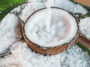 Pouring Fresh Coconut Milk And Coconut Fruit Ingredient On Wooden Table