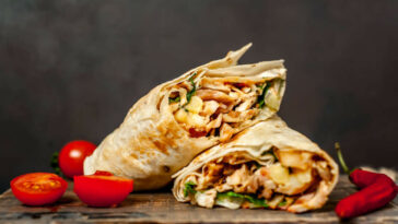 Burrito Wraps With Chicken And Vegetables On A Cutting Board, Against A Background Of Concrete, Mexican Shawarma