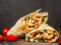 Burrito Wraps With Chicken And Vegetables On A Cutting Board, Against A Background Of Concrete, Mexican Shawarma