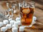 Soft Drink Glass Next To Sugar Cubes Arranged To Depict The Sugar Content, Emphasizing The Amount Of Sugar In The Beverage